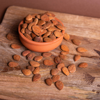 Sicilian shelled almonds in a 1kg bag by Mandorlino d'Olio, showcasing natural, whole almonds on a neutral background.