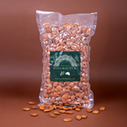 Shelled Sicilian almonds in a 1kg bag by Mandorlino d'Olio, showcasing their natural texture and color.