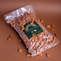 Shelled Sicilian almonds in a 1kg bag by Mandorlino d'Olio, showcasing a rustic packaging design.